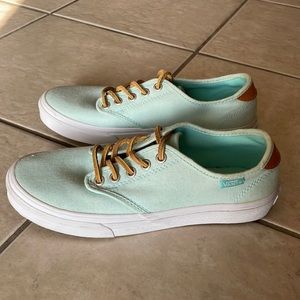 Light blue Vans with brown leather laces